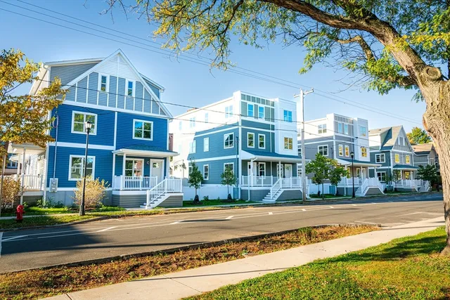 a front view of residential houses with yard