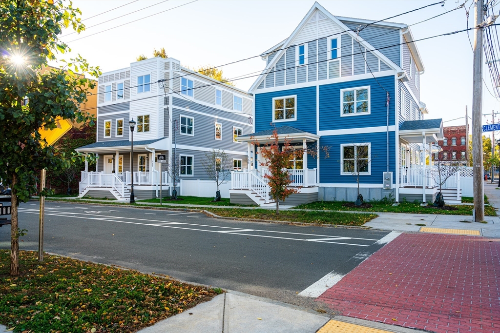 199 Clemente Street Holyoke, MA 01040 - Photo 3 of 16 a front view of a residential apartment building with a yard