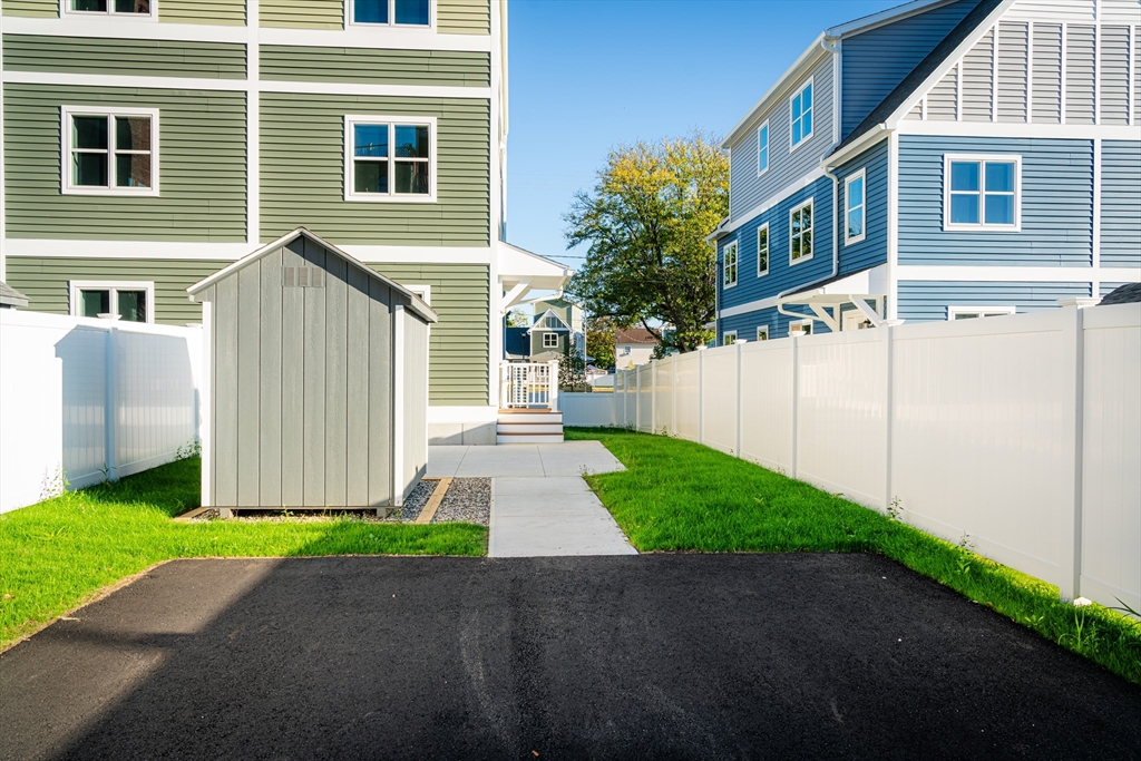 199 Clemente Street Holyoke, MA 01040 - Photo 4 of 16 a front view of a house with a yard and garage