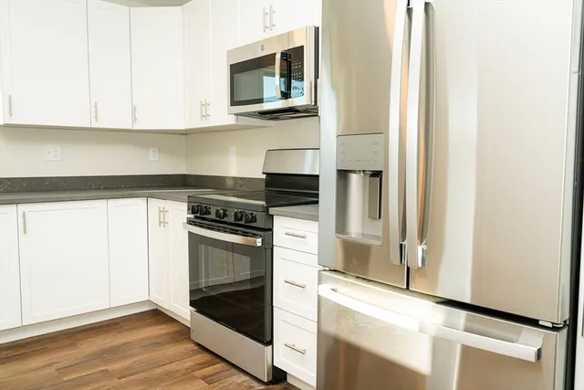 a kitchen with stainless steel appliances granite countertop a stove and a microwave