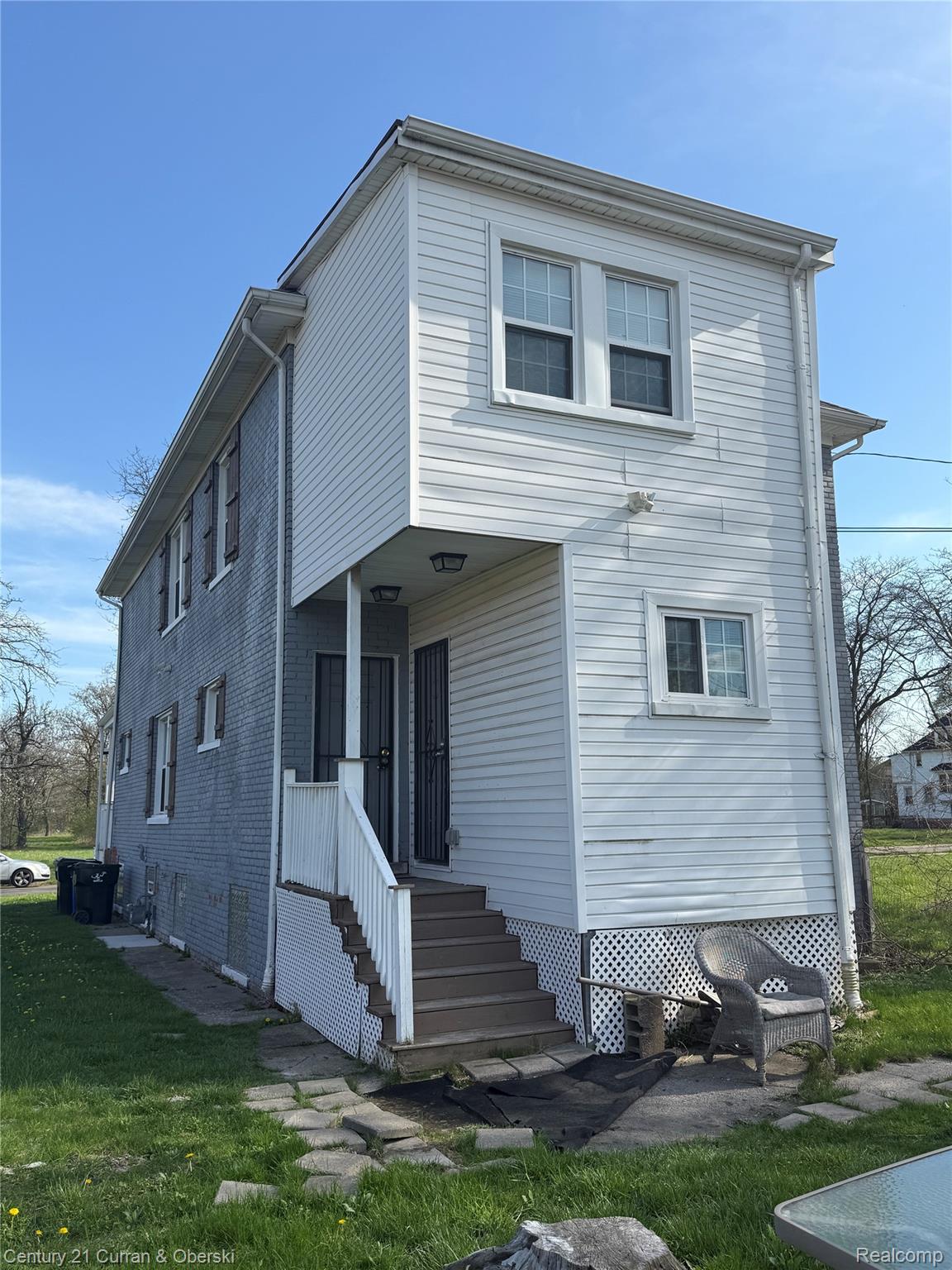 641 Josephine Street Detroit, MI 48202 - Photo 11 of 11 Two-story residential structure featuring white vinyl siding and a contrasting gray brick facade
