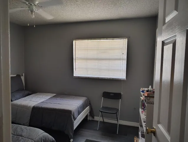 a bed sitting in a bedroom next to a lamp