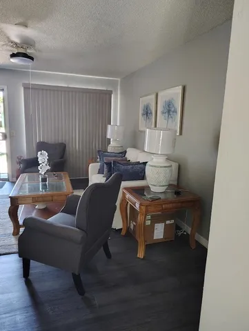a view of a workspace with furniture and wooden floor