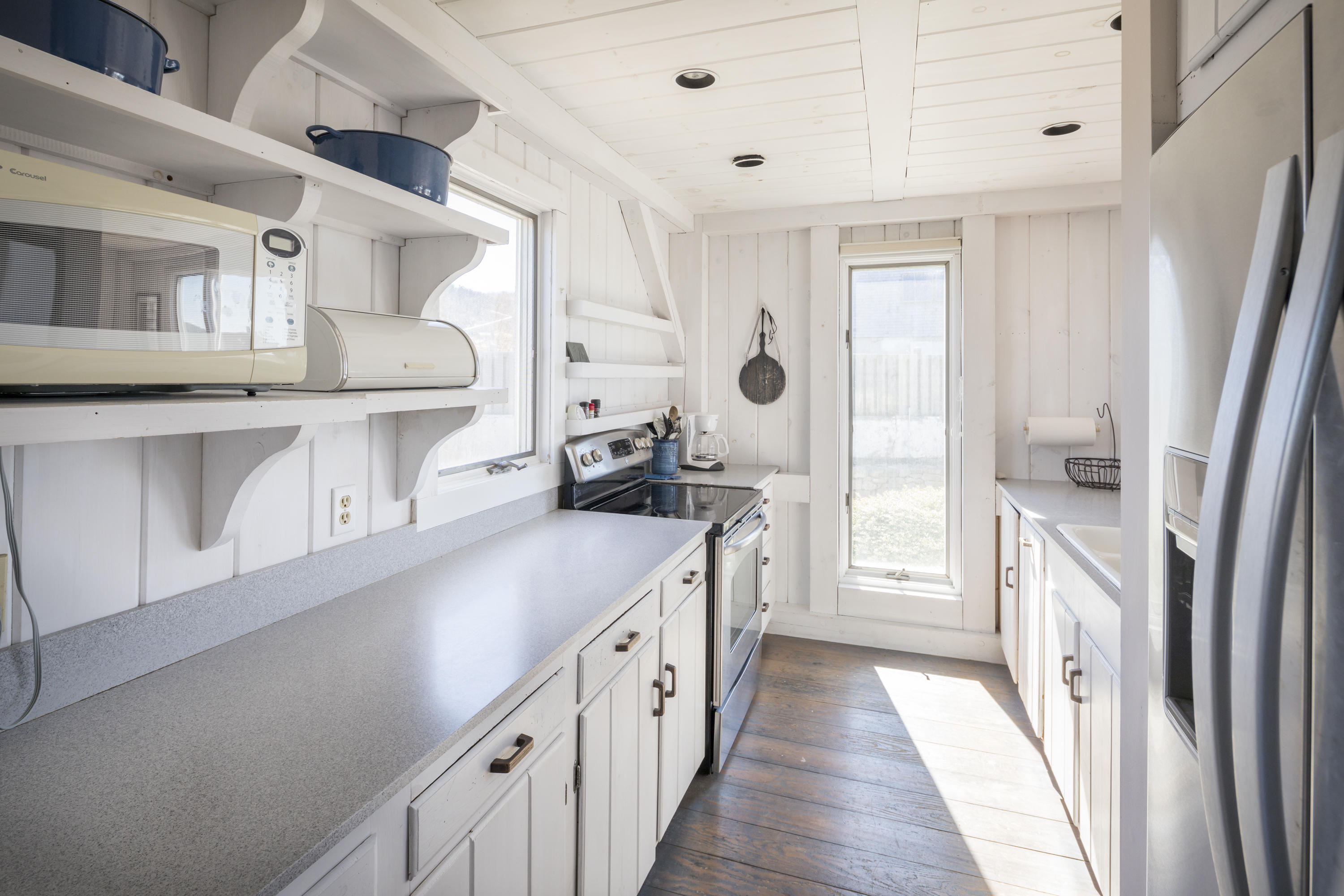 17 Bay View Road Truro, MA 02666 - Photo 14 of 40 a kitchen with stainless steel appliances a sink and a refrigerator