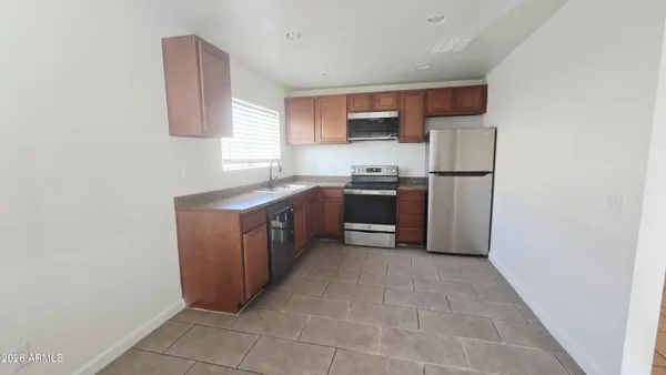 a kitchen with a sink cabinets and appliances