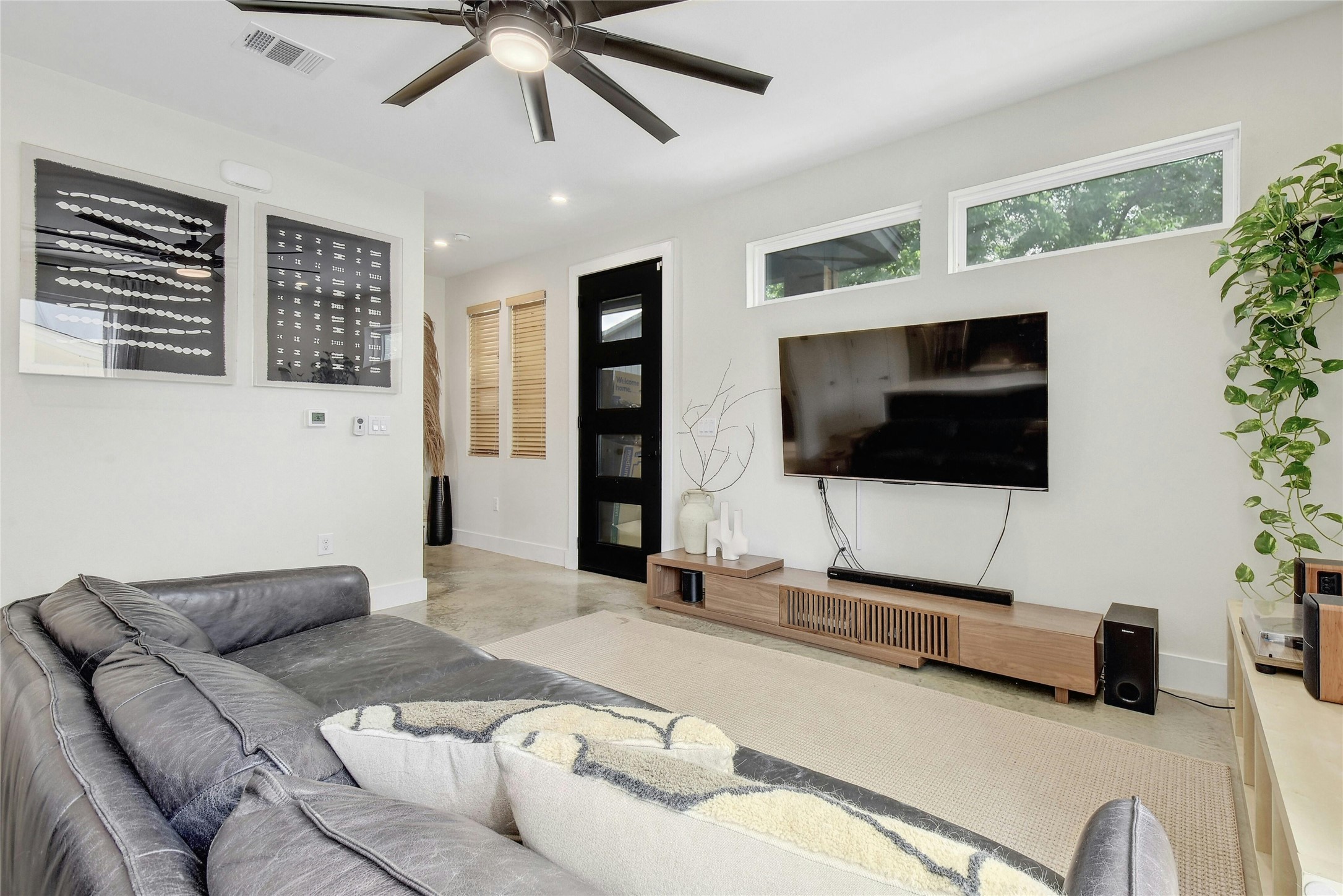 4606 Ledesma Road, Unit 2 Austin, TX 78721 - Photo 8 of 33 An inviting living room features ample space, high ceilings, and a seamless blend of modern comfort.