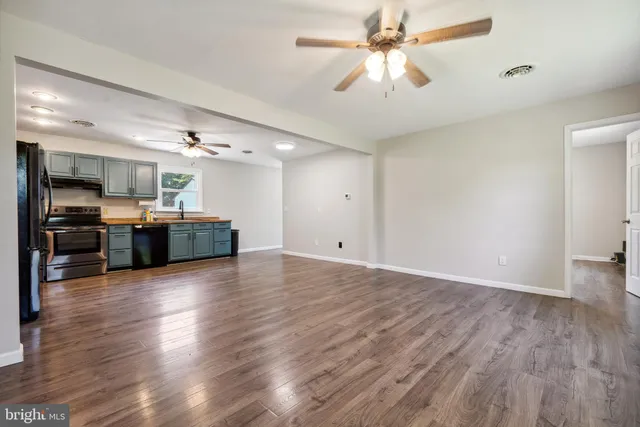 a view of a kitchen with a microwave and a ceiling fan