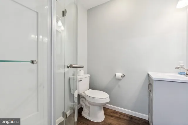 a bathroom with a toilet a sink and mirror
