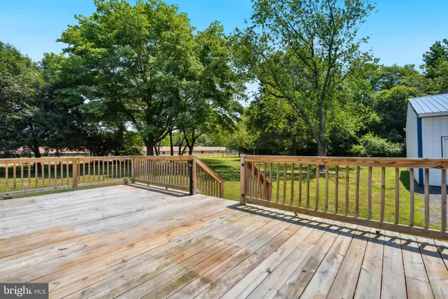 a view of a balcony with wooden floor and fence