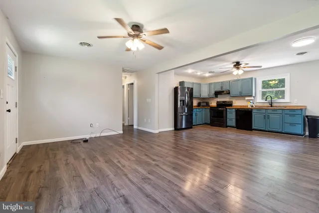a view of a kitchen with a sink and a refrigerator