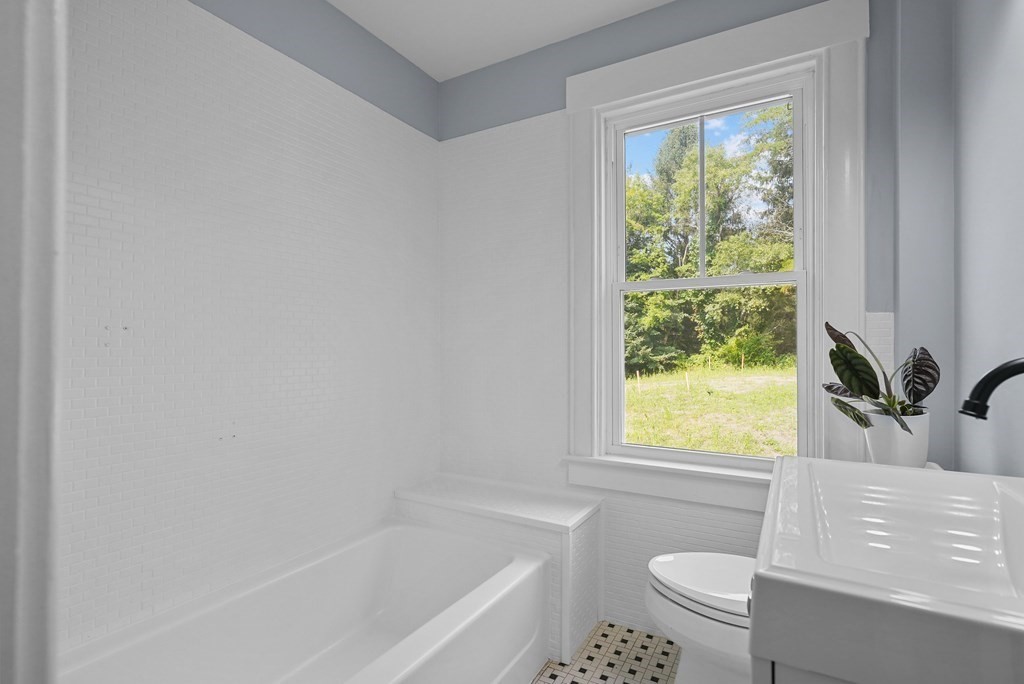 780 Williams Street Dighton, MA 02764 - Photo 21 of 39 a bath room with a toilet a bath tub and a window