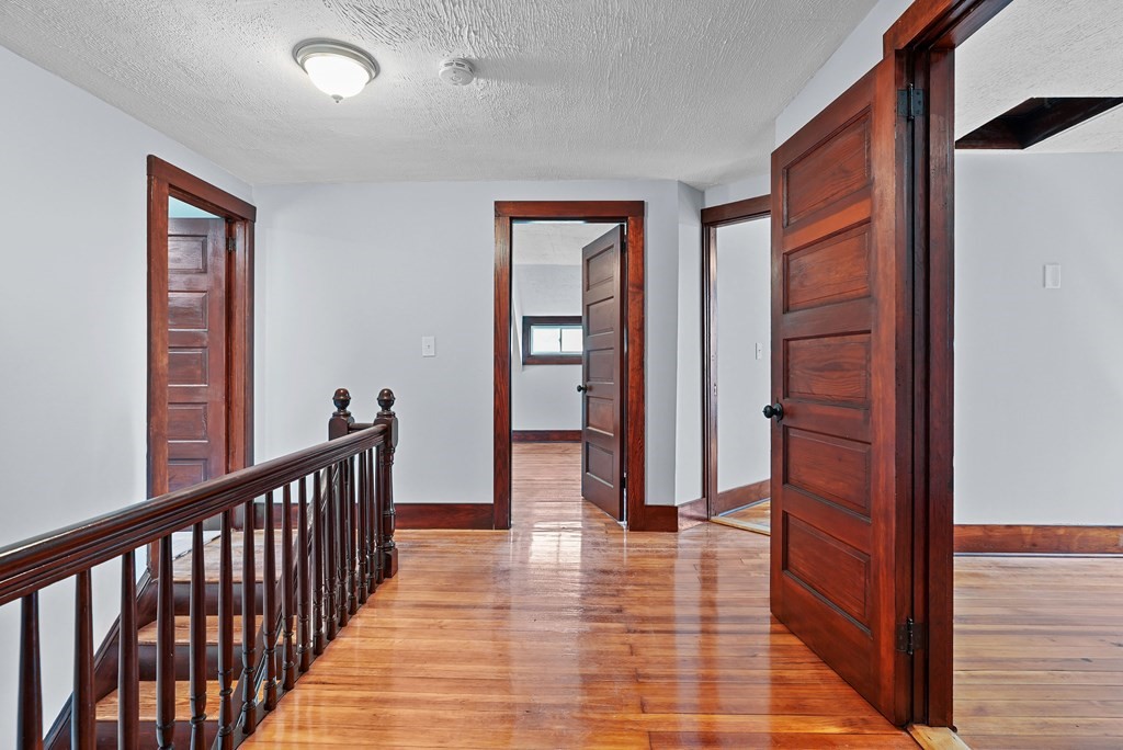 780 Williams Street Dighton, MA 02764 - Photo 23 of 39 a view of a hallway with wooden floor and staircase
