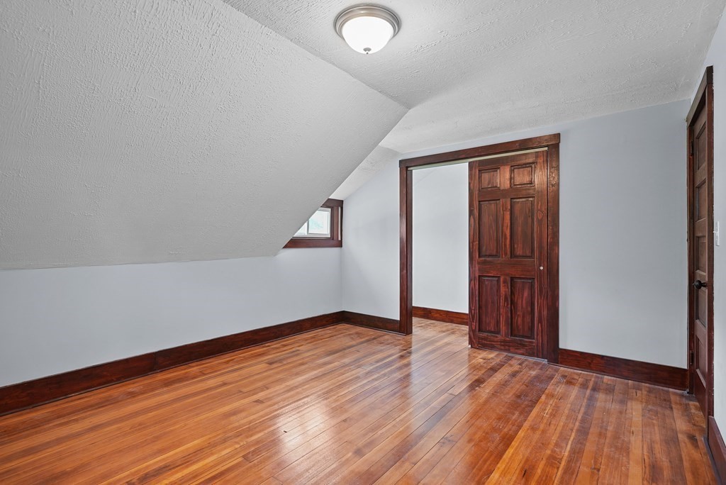 780 Williams Street Dighton, MA 02764 - Photo 28 of 39 an empty room with wooden floor and windows