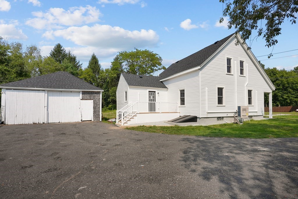 780 Williams Street Dighton, MA 02764 - Photo 5 of 39 a view of a white house next to a yard and a large tree