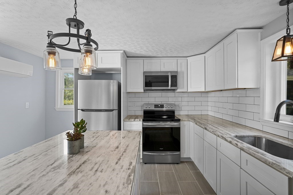 780 Williams Street Dighton, MA 02764 - Photo 8 of 39 a kitchen with a sink appliances and cabinets