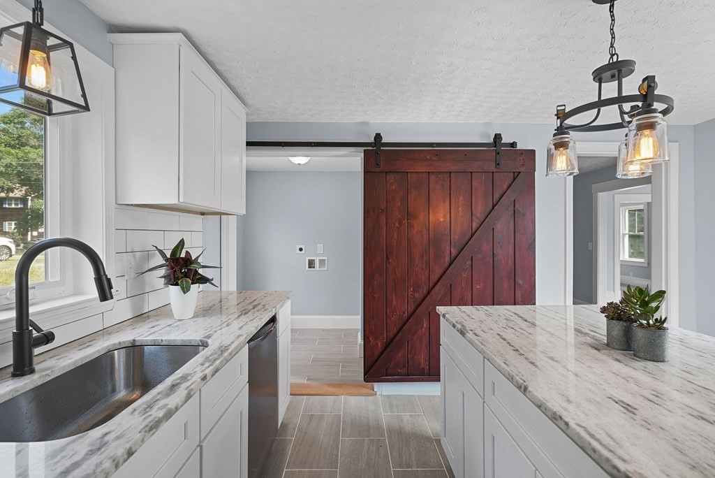780 Williams Street Dighton, MA 02764 - Photo 10 of 39 a kitchen with kitchen island granite countertop a sink stainless steel appliances and a counter space