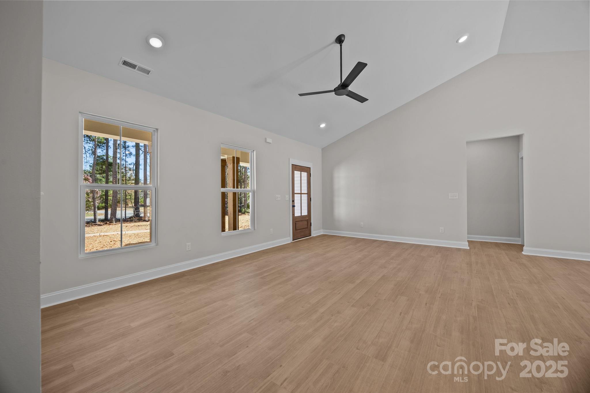 2307 Lee Lawing Road Lincolnton, NC 28092 - Photo 11 of 40 a view of an empty room with a window and wooden floor