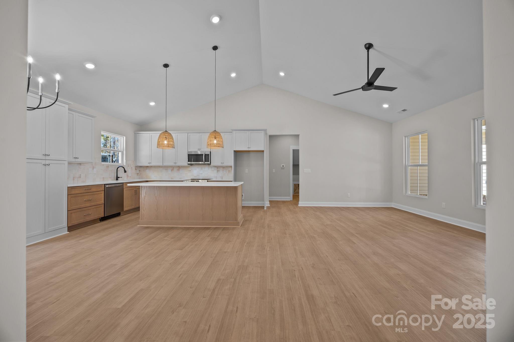 2307 Lee Lawing Road Lincolnton, NC 28092 - Photo 12 of 40 a large kitchen with stainless steel appliances a large counter top a sink a refrigerator and a window