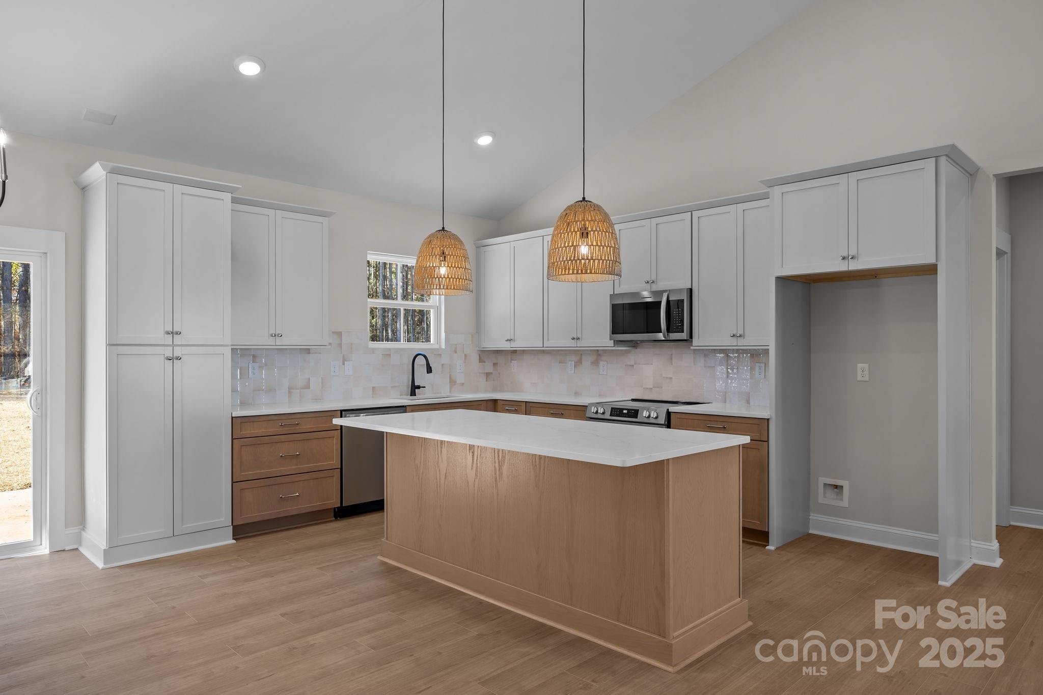 2307 Lee Lawing Road Lincolnton, NC 28092 - Photo 15 of 40 a kitchen with stainless steel appliances granite countertop a sink a stove and a refrigerator