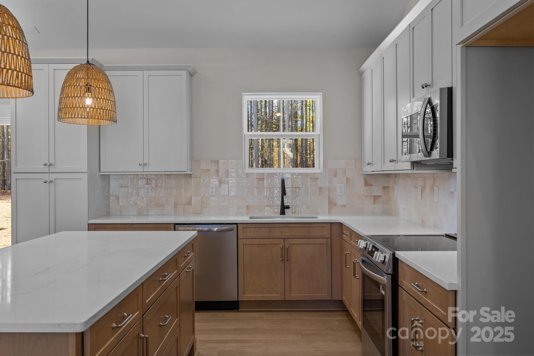 2307 Lee Lawing Road Lincolnton, NC 28092 - Photo 17 of 40 a kitchen with stainless steel appliances a sink a stove and a refrigerator