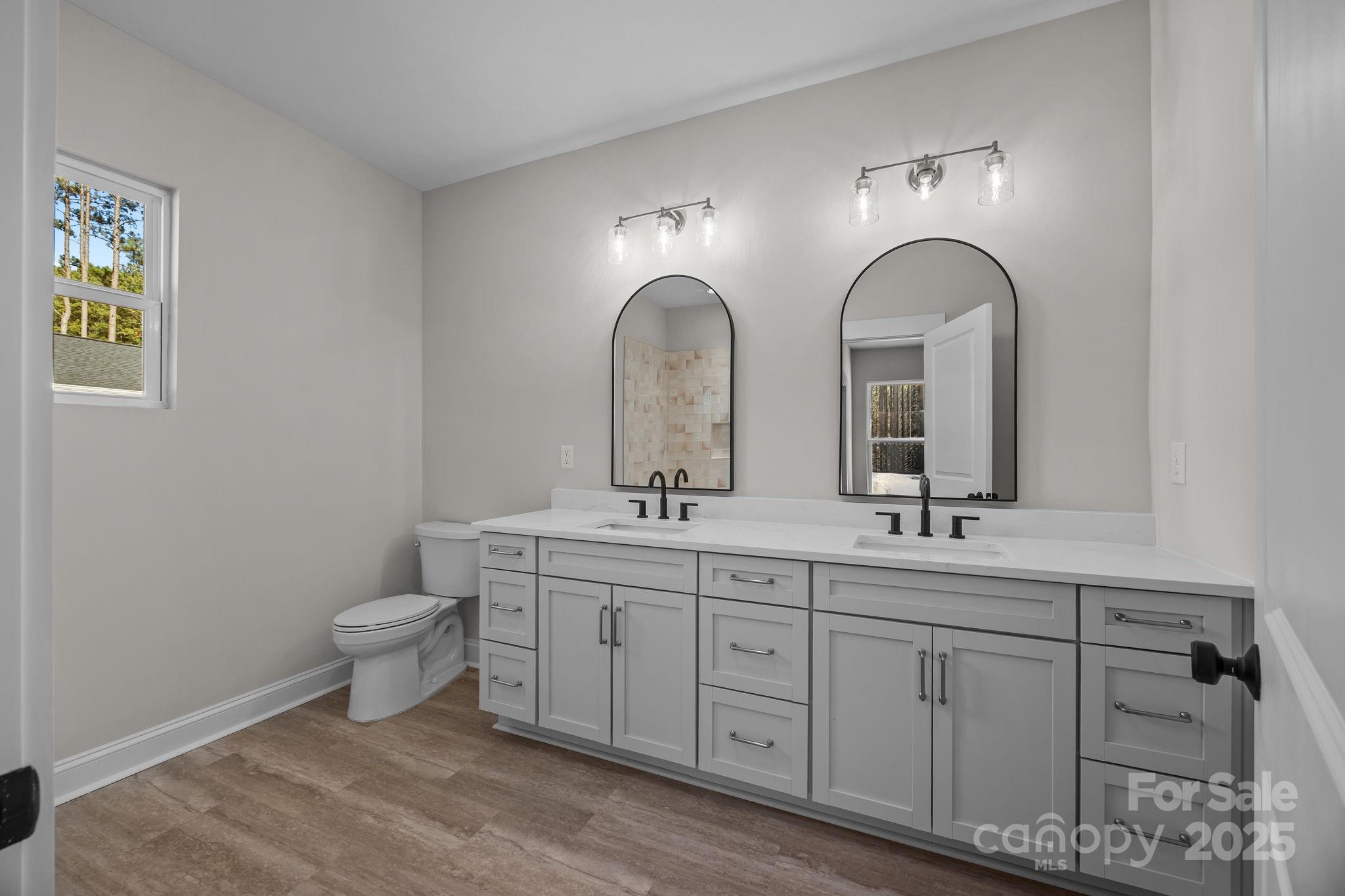 2307 Lee Lawing Road Lincolnton, NC 28092 - Photo 24 of 40 a bathroom with 2 sink toilet and a mirror