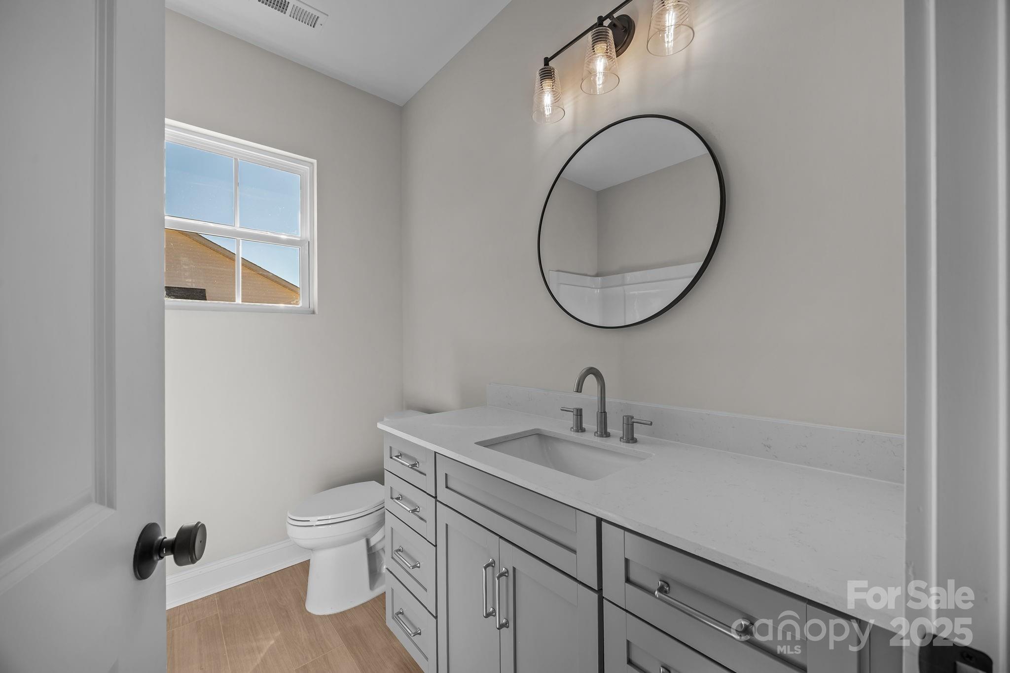 2307 Lee Lawing Road Lincolnton, NC 28092 - Photo 28 of 40 a bathroom with a toilet sink and mirror