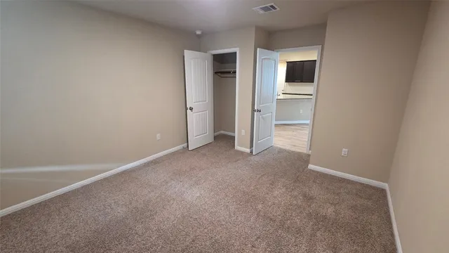 a view of an empty room and fire place