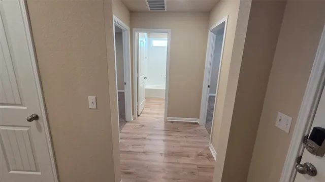 a view of a bathroom from a hallway