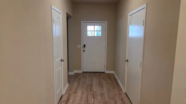 a view of a hallway with wooden floor