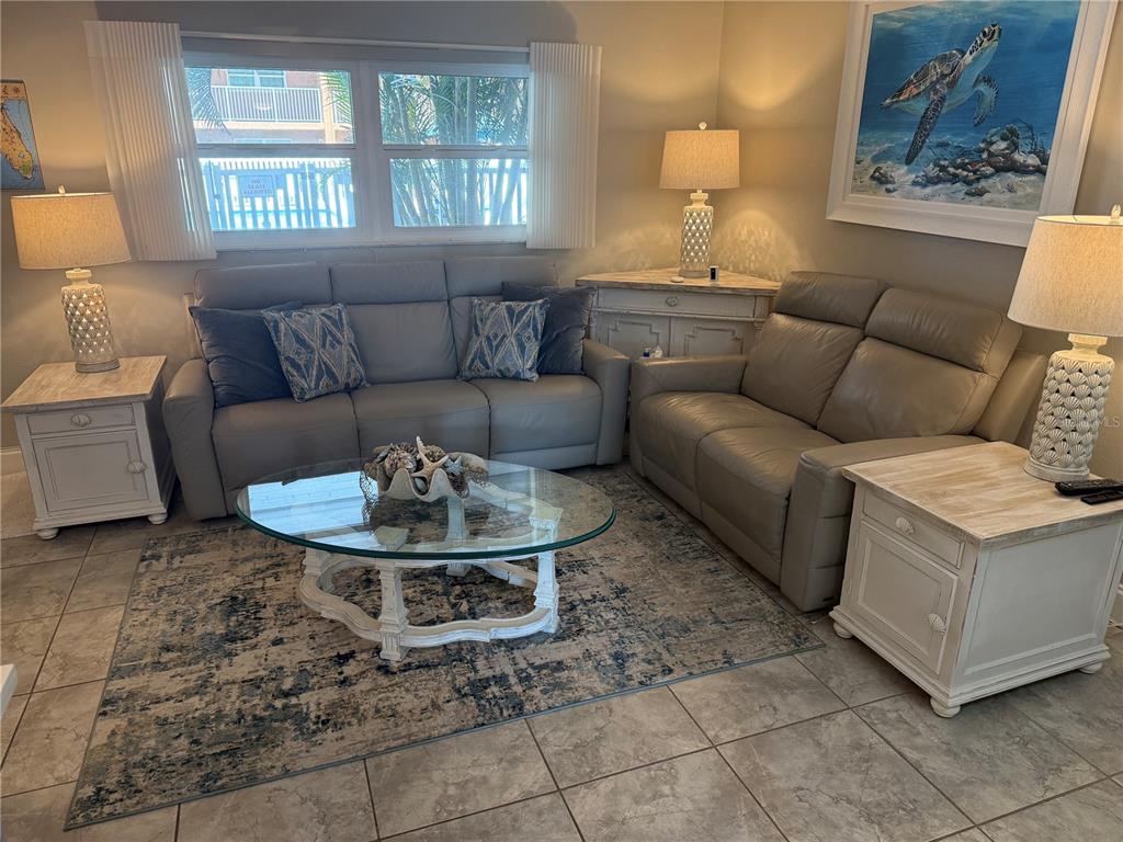 12760 Indian Rocks Road, Unit 1024 Largo, FL 33774 - Photo 11 of 35 a living room with furniture a window and a table