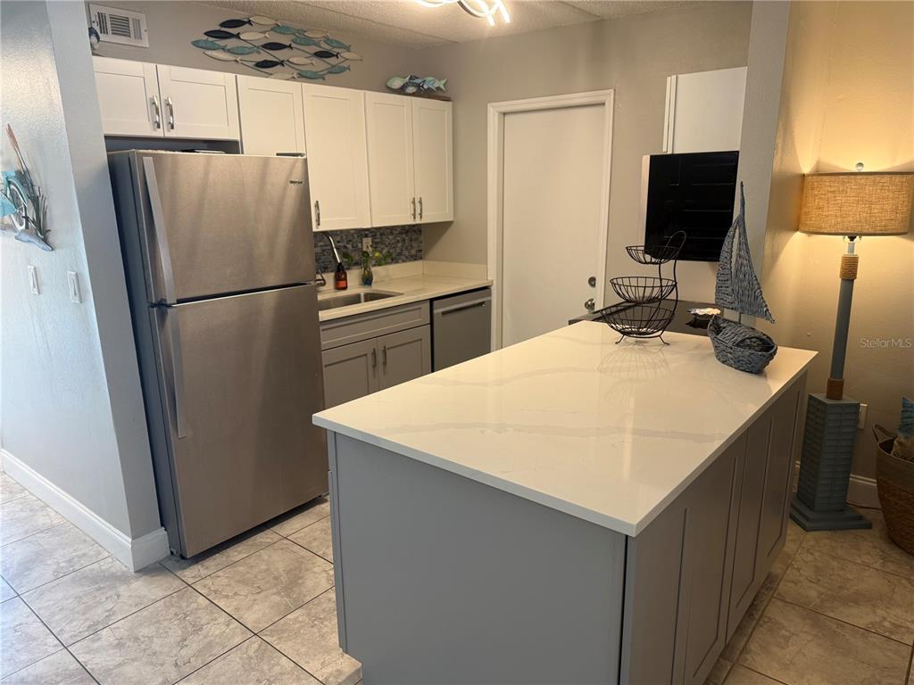 12760 Indian Rocks Road, Unit 1024 Largo, FL 33774 - Photo 14 of 35 a kitchen with a refrigerator a sink and a refrigerator