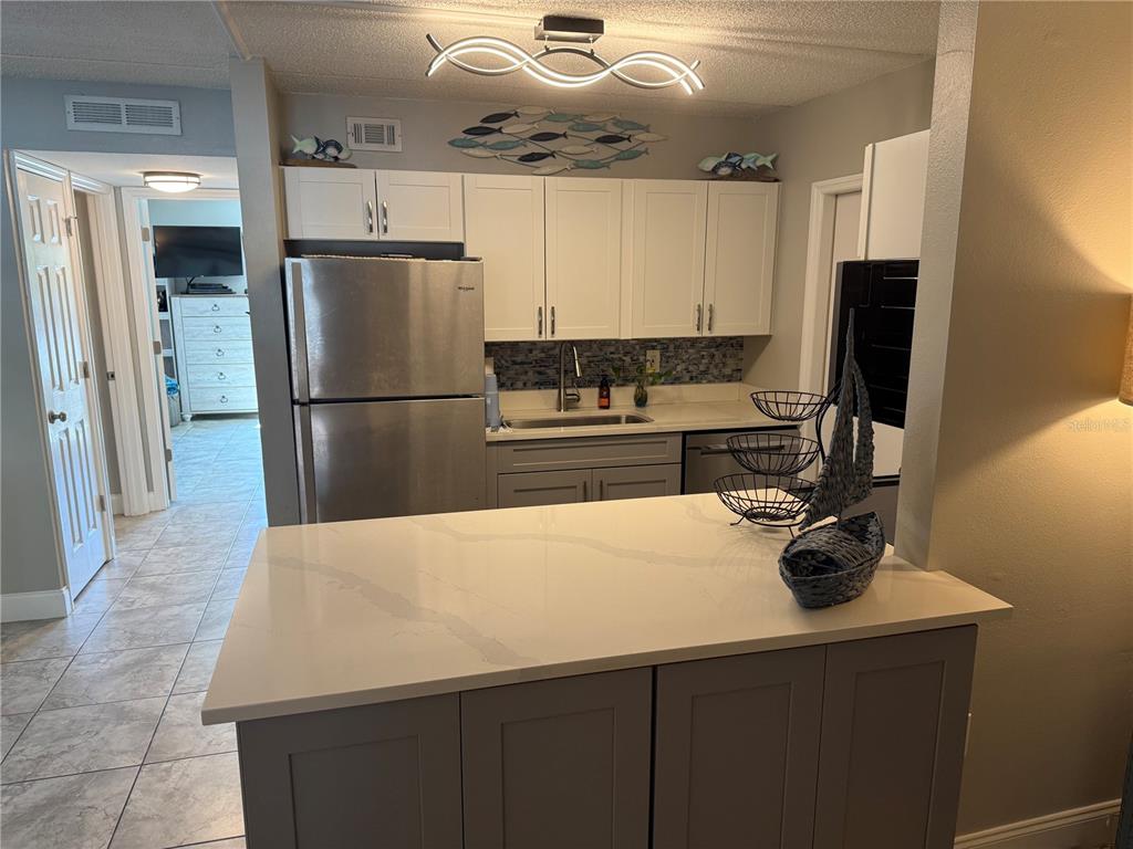 12760 Indian Rocks Road, Unit 1024 Largo, FL 33774 - Photo 17 of 35 a kitchen with a refrigerator and a sink