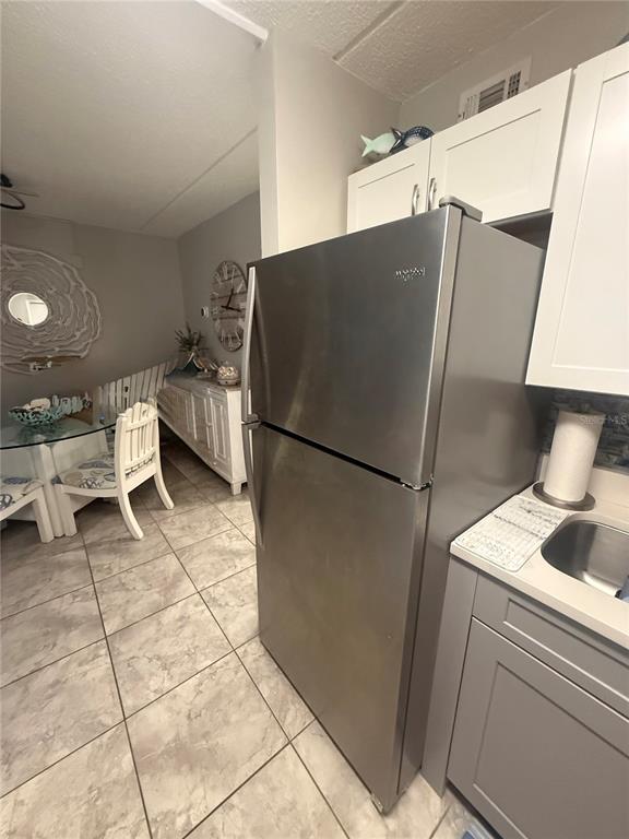 12760 Indian Rocks Road, Unit 1024 Largo, FL 33774 - Photo 21 of 35 a kitchen with a refrigerator and a sink