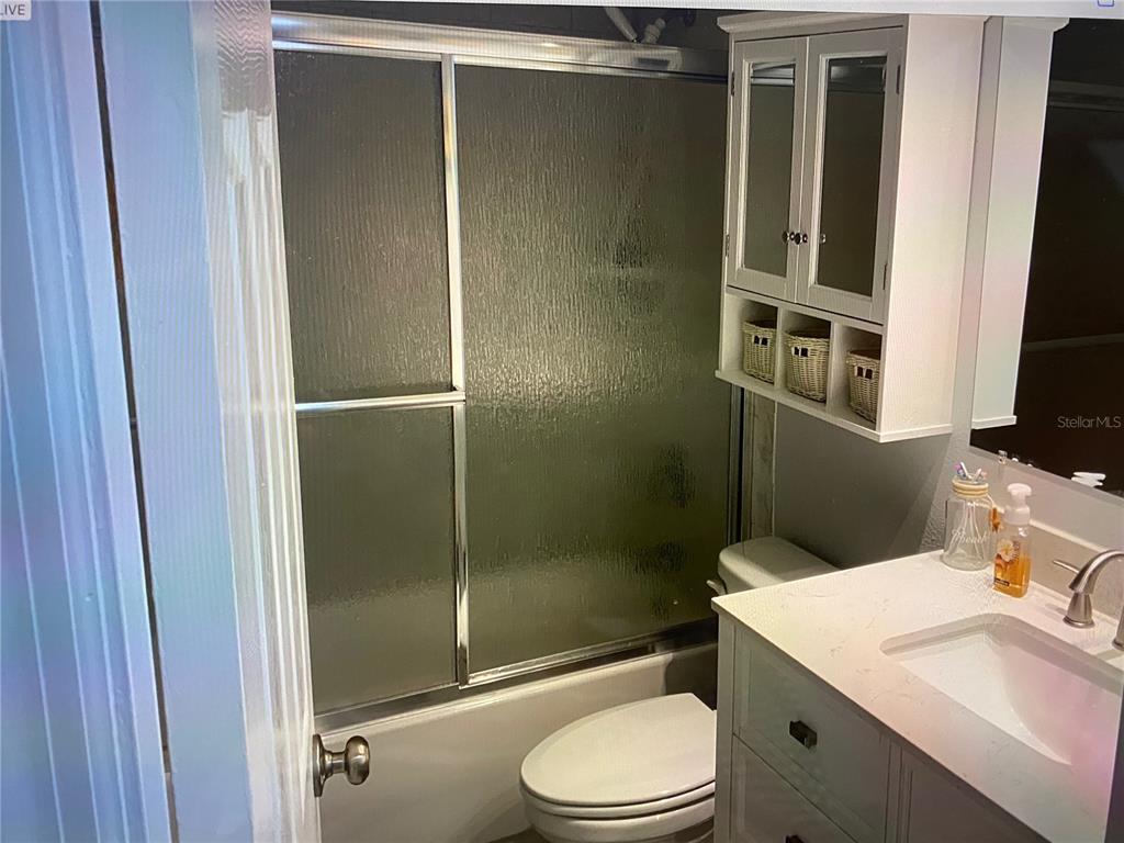 12760 Indian Rocks Road, Unit 1024 Largo, FL 33774 - Photo 22 of 35 a bathroom with a sink a toilet and shower