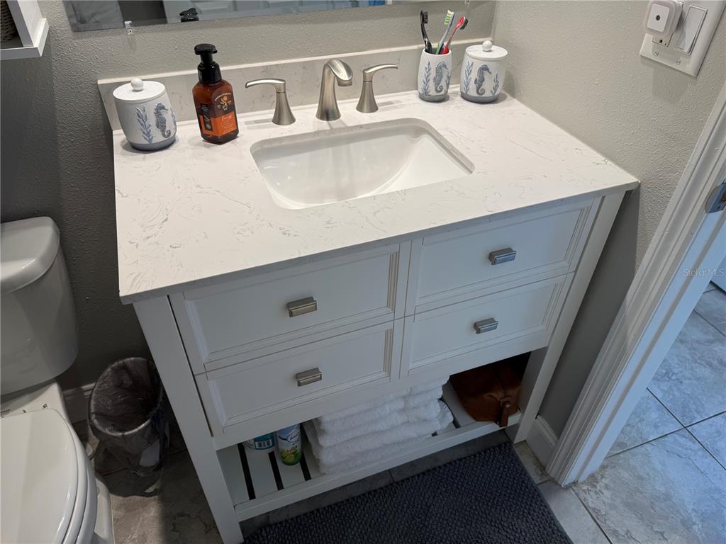 12760 Indian Rocks Road, Unit 1024 Largo, FL 33774 - Photo 24 of 35 a bathroom with a sink and a toilet