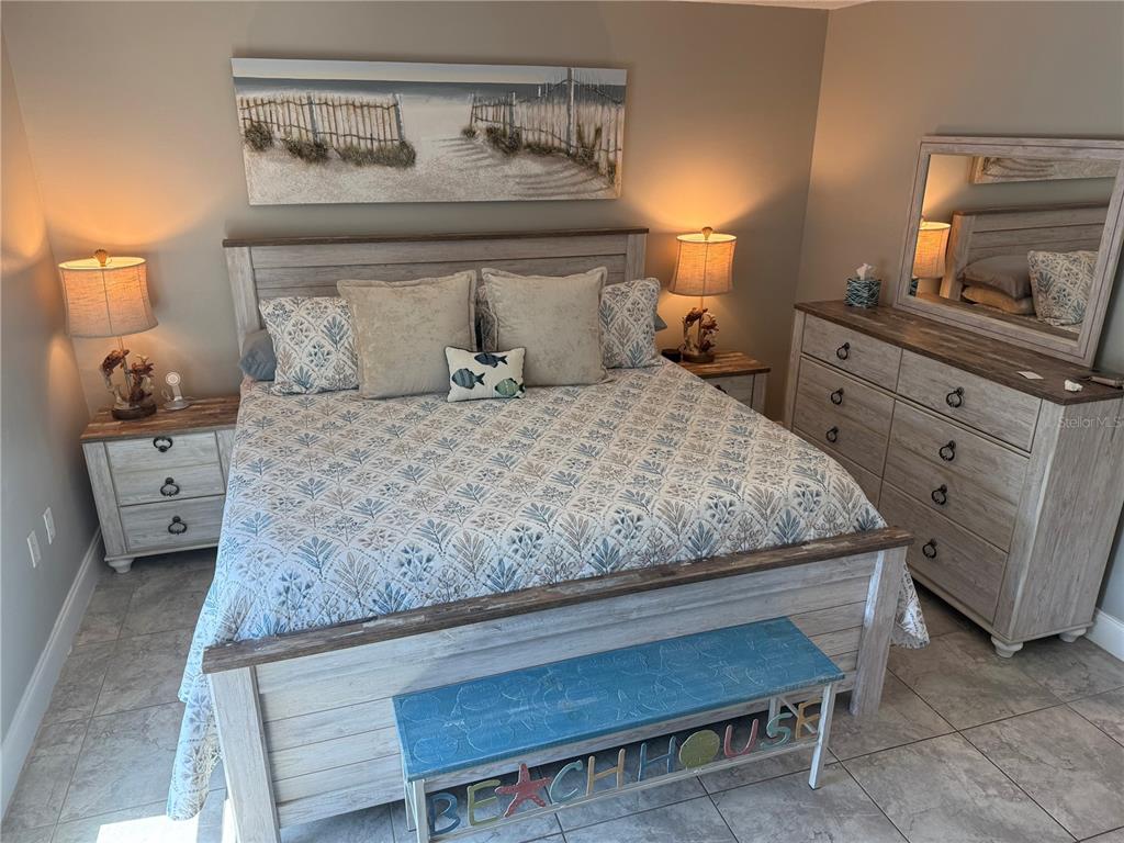 12760 Indian Rocks Road, Unit 1024 Largo, FL 33774 - Photo 25 of 35 a bedroom with a bed and furniture