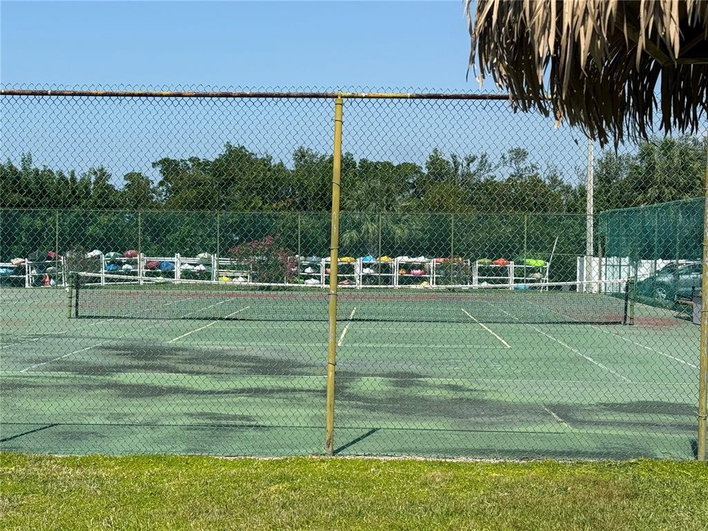 12760 Indian Rocks Road, Unit 1024 Largo, FL 33774 - Photo 29 of 35 a view of a swimming pool with a lawn chairs under an umbrella