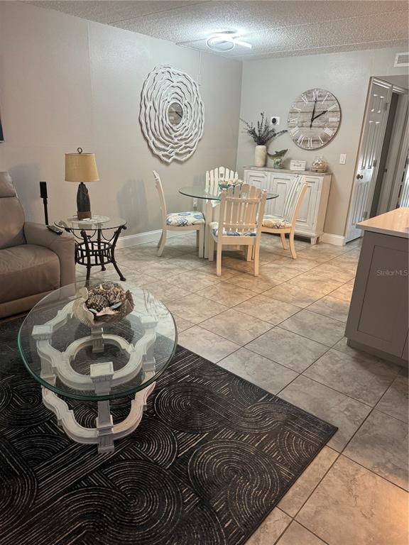12760 Indian Rocks Road, Unit 1024 Largo, FL 33774 - Photo 9 of 35 a living room with furniture a rug and a table