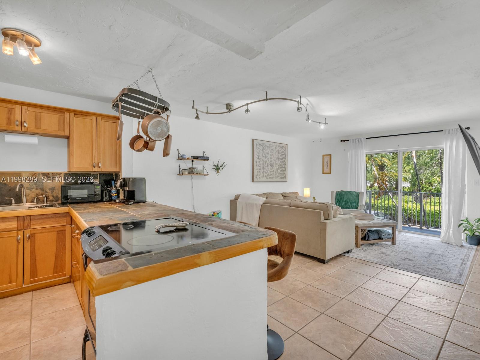 7403 Southwest 82nd Street, Unit 201N Miami, FL 33143 - Photo 13 of 43 a kitchen that has a cabinets and a stove