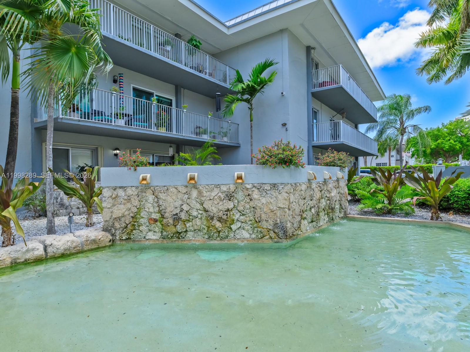 7403 Southwest 82nd Street, Unit 201N Miami, FL 33143 - Photo 8 of 43 a front view of a house with garden
