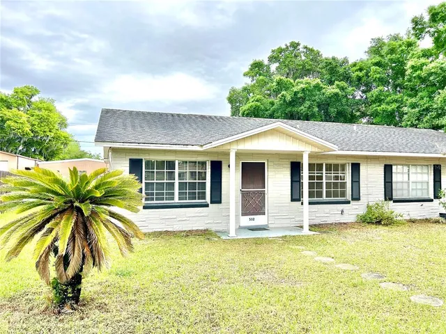 a front view of house with yard outdoor seating and barbeque oven