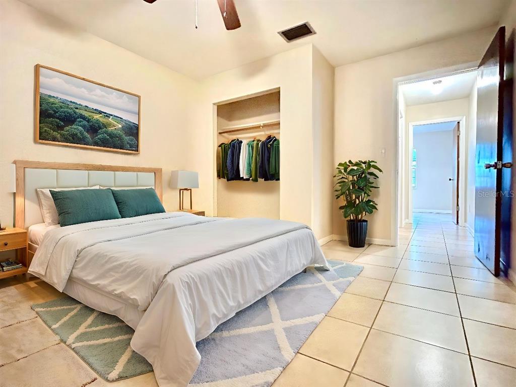 530 Park Avenue, Unit 532 Umatilla, FL 32784 - Photo 13 of 26 a bedroom with a bed and a painting on the wall