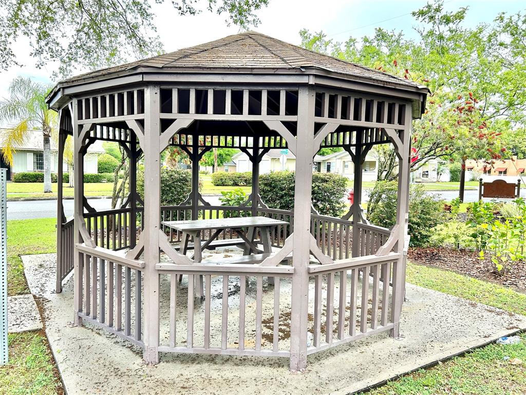 530 Park Avenue, Unit 532 Umatilla, FL 32784 - Photo 21 of 26 a view of a brick house with large windows and a wooden deck