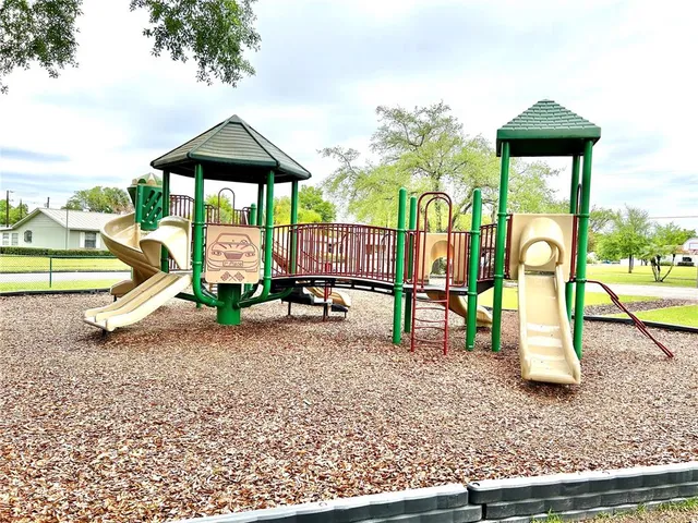 a view of outdoor space with playground and green space