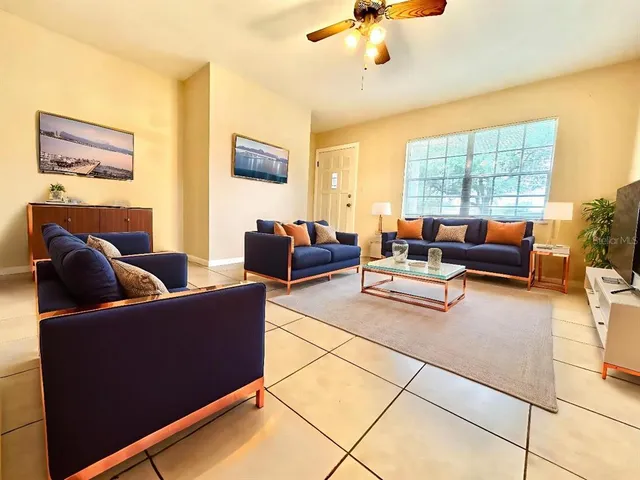 a living room with furniture and a large window