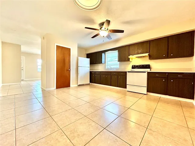 a kitchen with stainless steel appliances a cabinets and chandelier