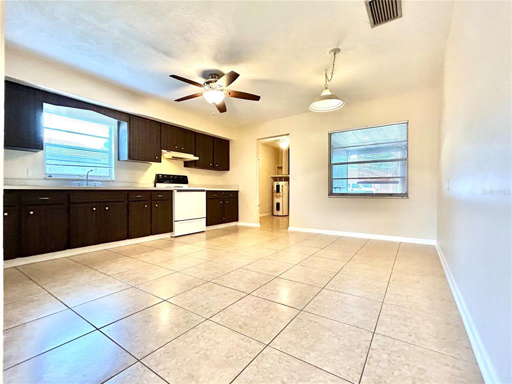 530 Park Avenue, Unit 532 Umatilla, FL 32784 - Photo 8 of 26 a large kitchen with stainless steel appliances kitchen island granite countertop a refrigerator and a stove top oven