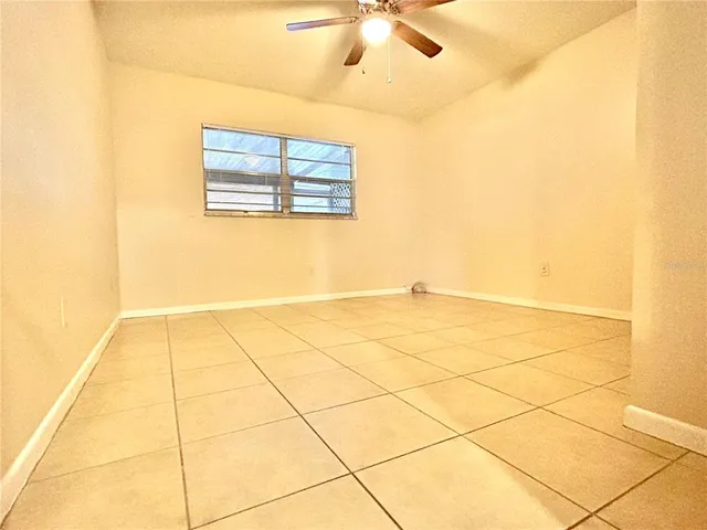 a view of a room with wooden floor and white walls