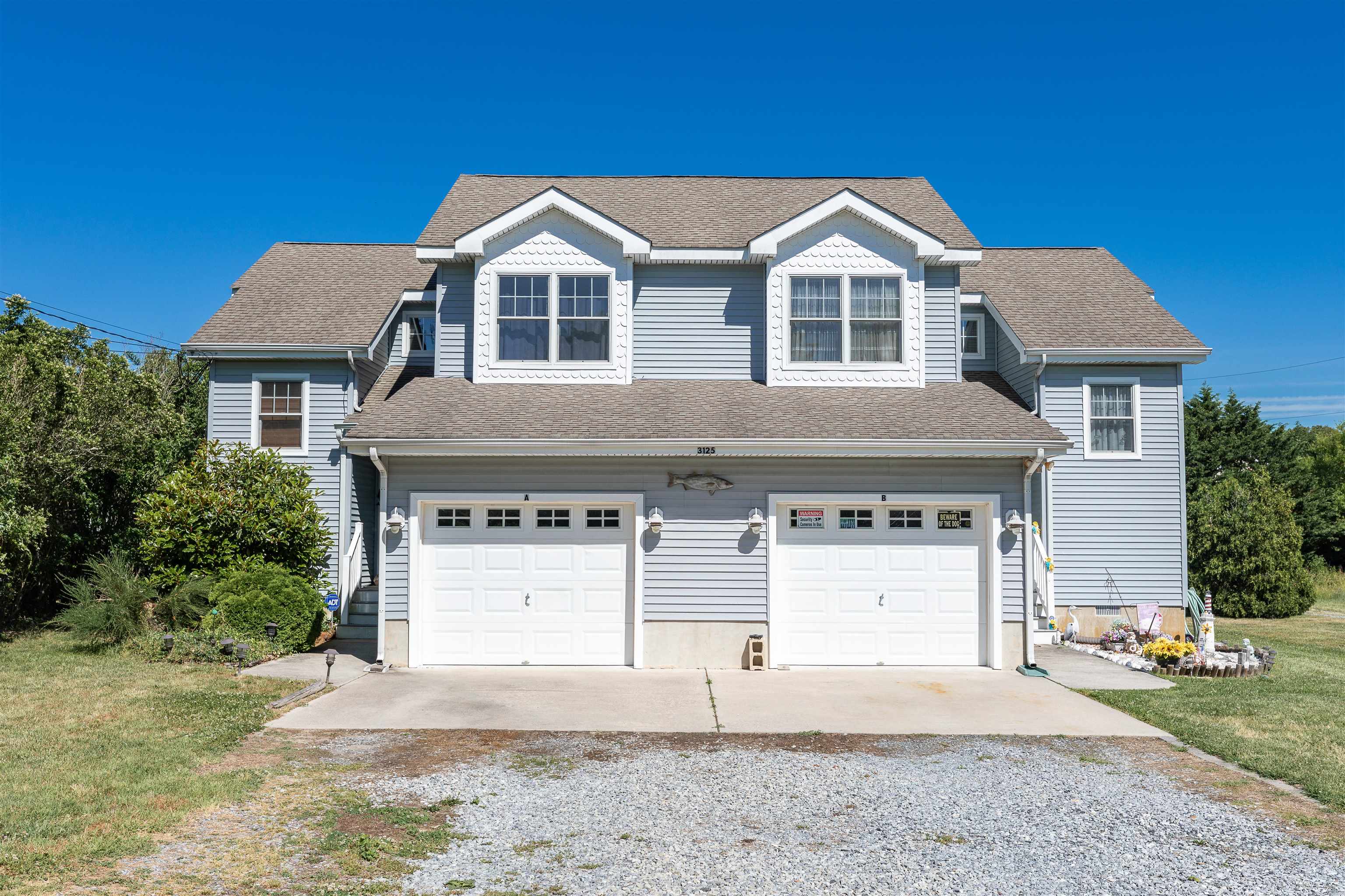 3125 Shunpike Road, Unit A Rio Grande, NJ 08242 - Photo 1 of 41 a view of a white house with a yard and large tree