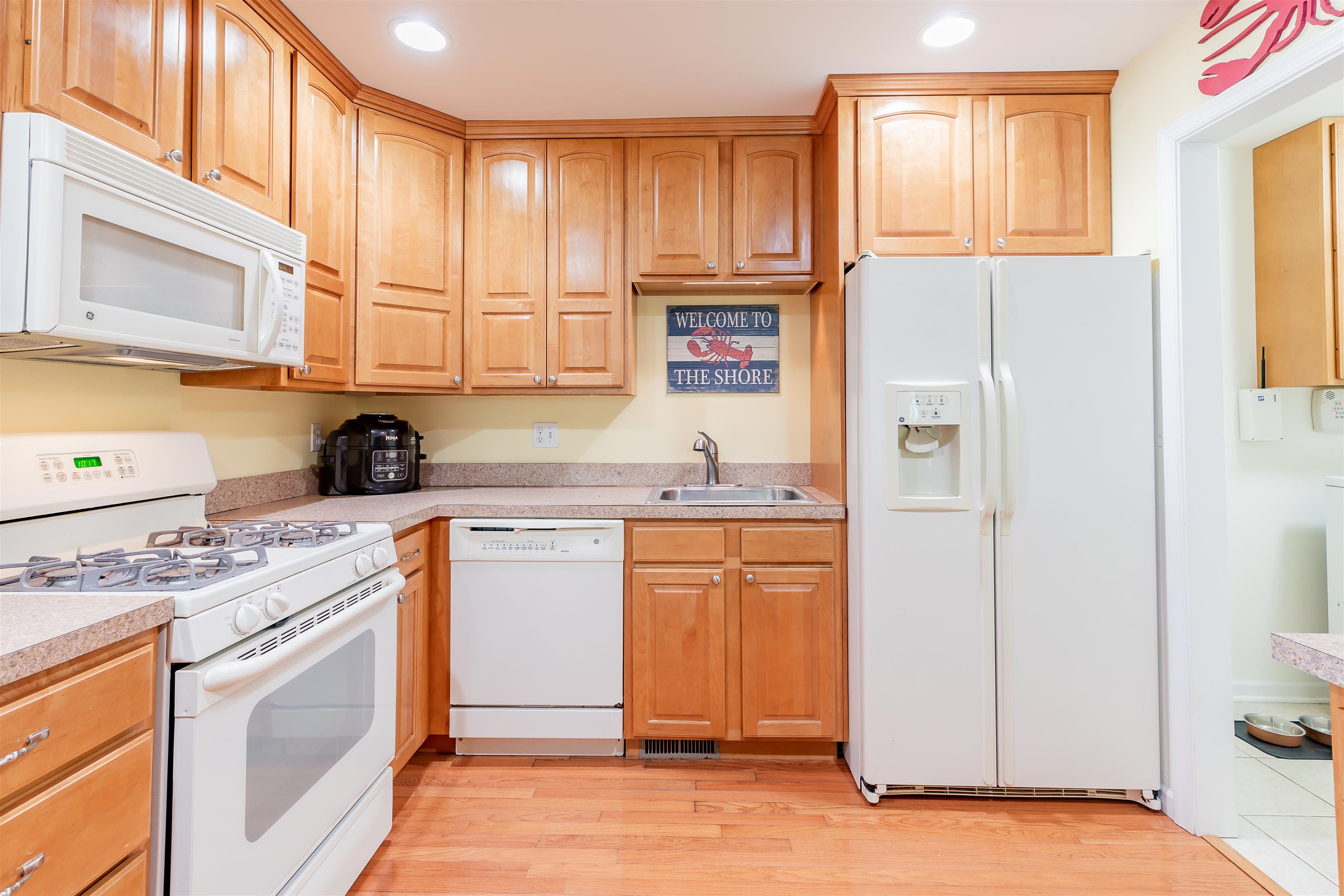 3125 Shunpike Road, Unit A Rio Grande, NJ 08242 - Photo 19 of 41 a kitchen with stainless steel appliances granite countertop a refrigerator and a stove top oven